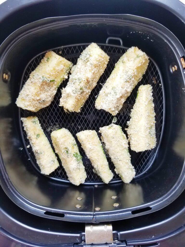 zucchini fries in air fryer basket before cooking