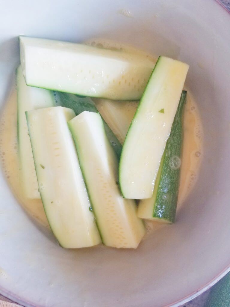 dipping zucchini fries in egg wash