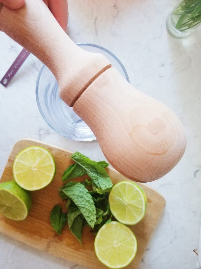 pestle with mojito ingredients in the background 