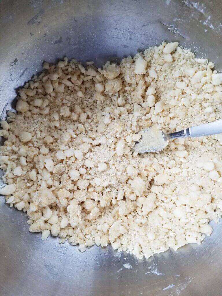 mixing the egg into the pie crust dough