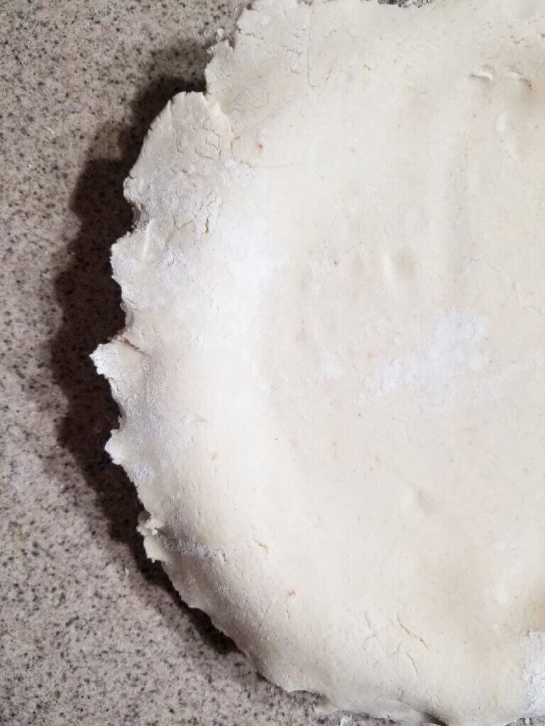 shaping the Gluten Free Pie Crust to the pie dish 