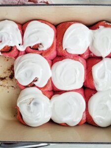 pink cinnamon rolls with frosting