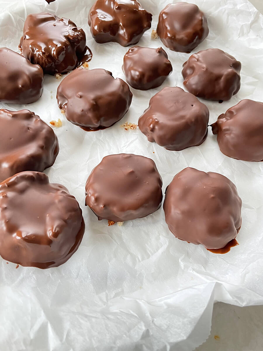 almond pulp thumbprint cookies dipped in dark chocolate