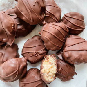 chocolate dipped almond pulp cookies with date caramel