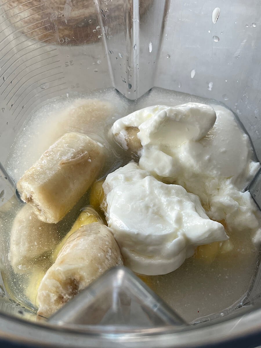 frozen banana, pineapple, cucumber, and yogurt in a blender with coconut water