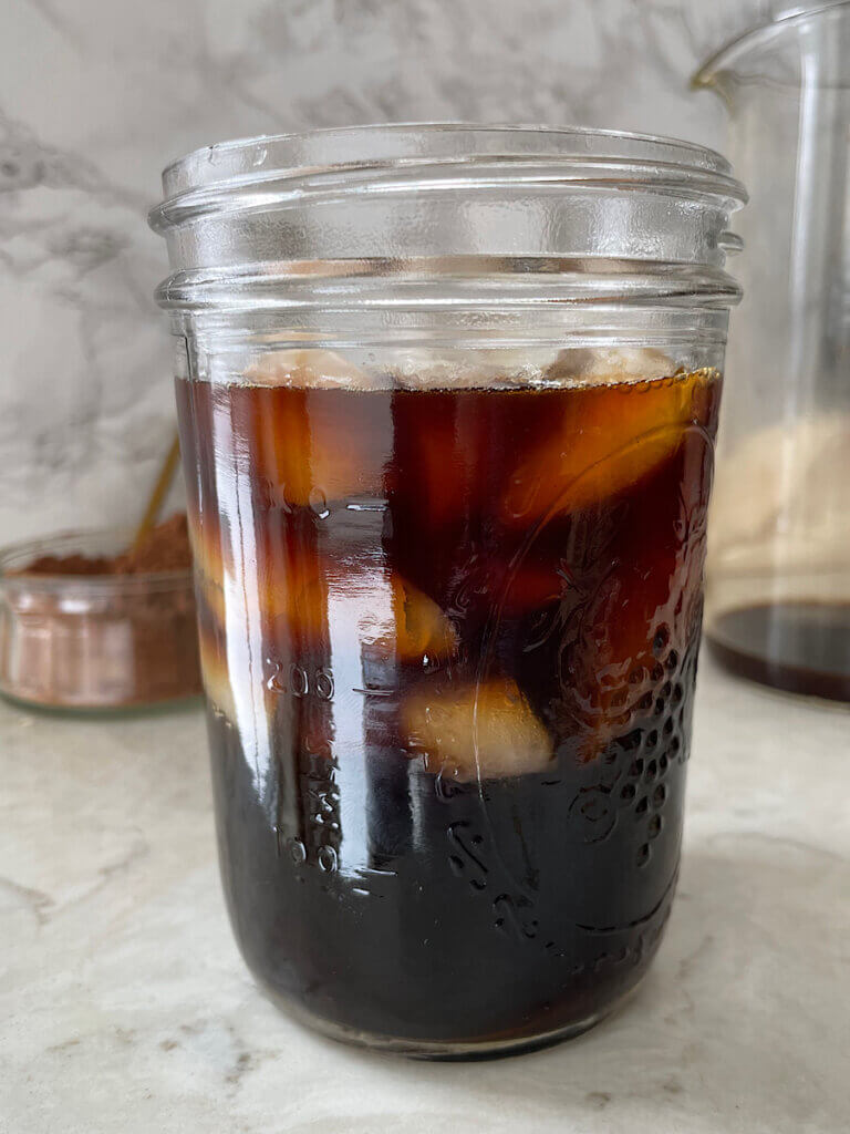 mason jar filled with black iced coffee