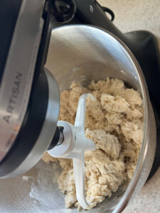 mixing sourdough cinnamon bun dough in a standing mixer
